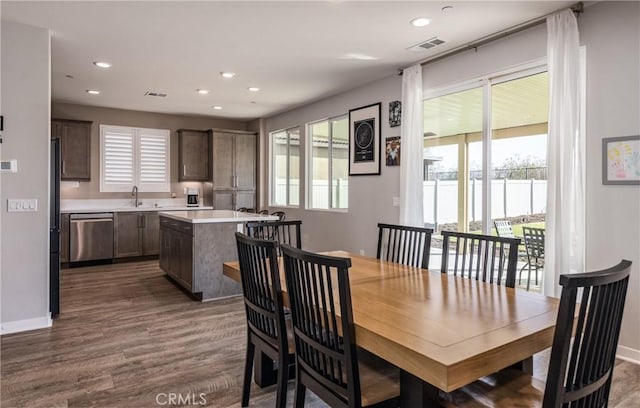 dining room with dark wood-type flooring and sink