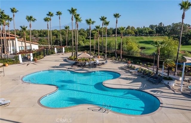 community pool featuring a patio area and fence