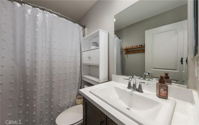 bathroom with vanity, curtained shower, and toilet