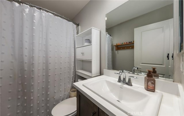 bathroom with curtained shower, vanity, and toilet