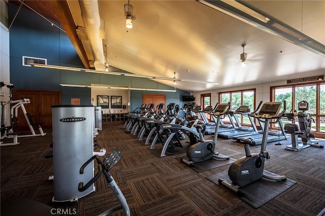 workout area with carpet floors, visible vents, high vaulted ceiling, and a ceiling fan