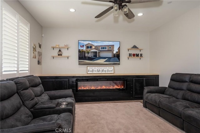 living room featuring ceiling fan and light carpet