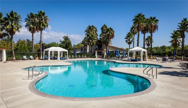 pool featuring a gazebo, a patio area, and fence