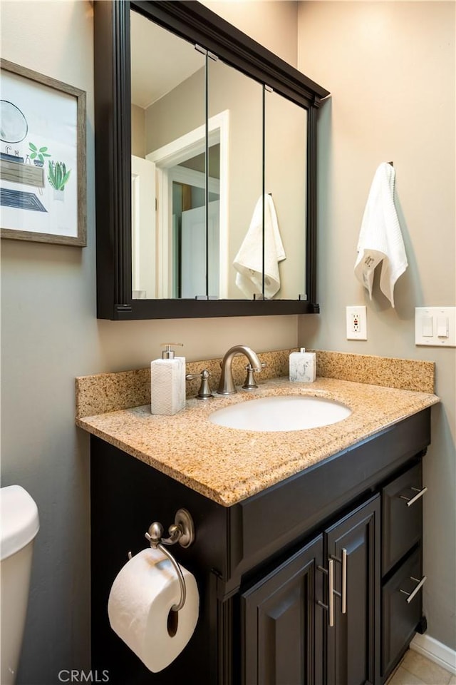 bathroom featuring vanity and toilet