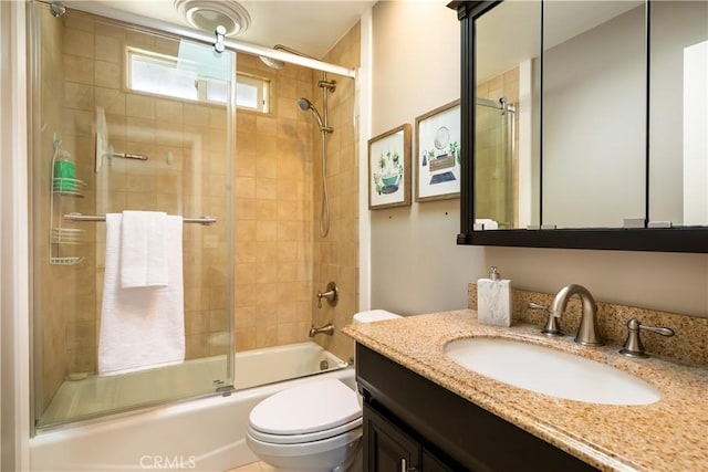 full bathroom with vanity, shower / bath combination with glass door, and toilet