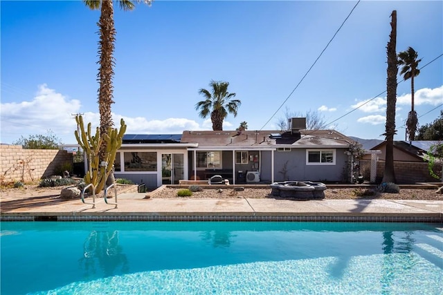 view of pool with central AC unit and a patio area