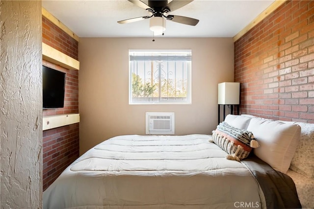 bedroom featuring ceiling fan, brick wall, and an AC wall unit