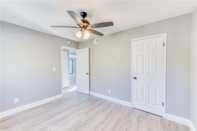 unfurnished bedroom with ceiling fan and light hardwood / wood-style flooring