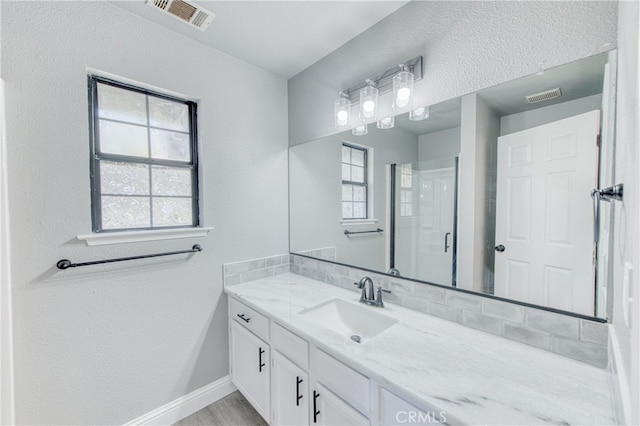 bathroom with vanity and walk in shower