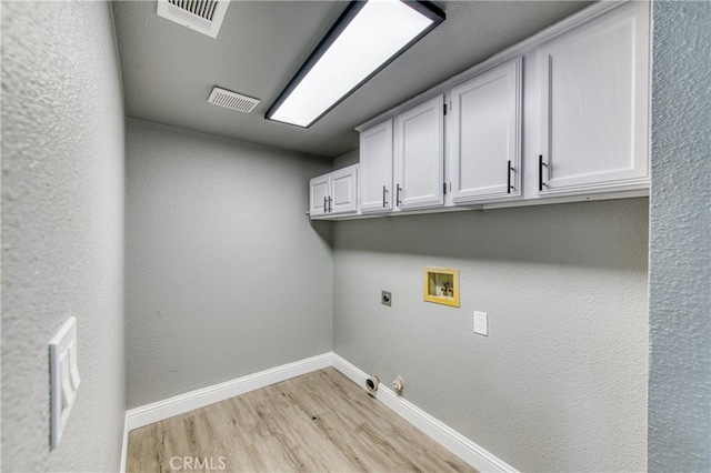 laundry room with cabinets, hookup for a gas dryer, washer hookup, light hardwood / wood-style floors, and electric dryer hookup