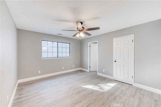 unfurnished bedroom with ceiling fan and light hardwood / wood-style floors