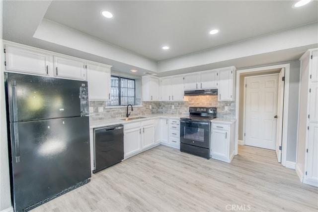 kitchen with white cabinetry, sink, light wood-type flooring, and black appliances