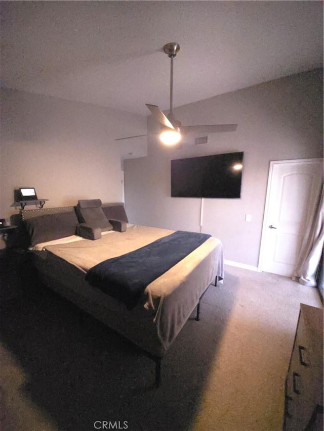 bedroom with vaulted ceiling, carpet flooring, and ceiling fan