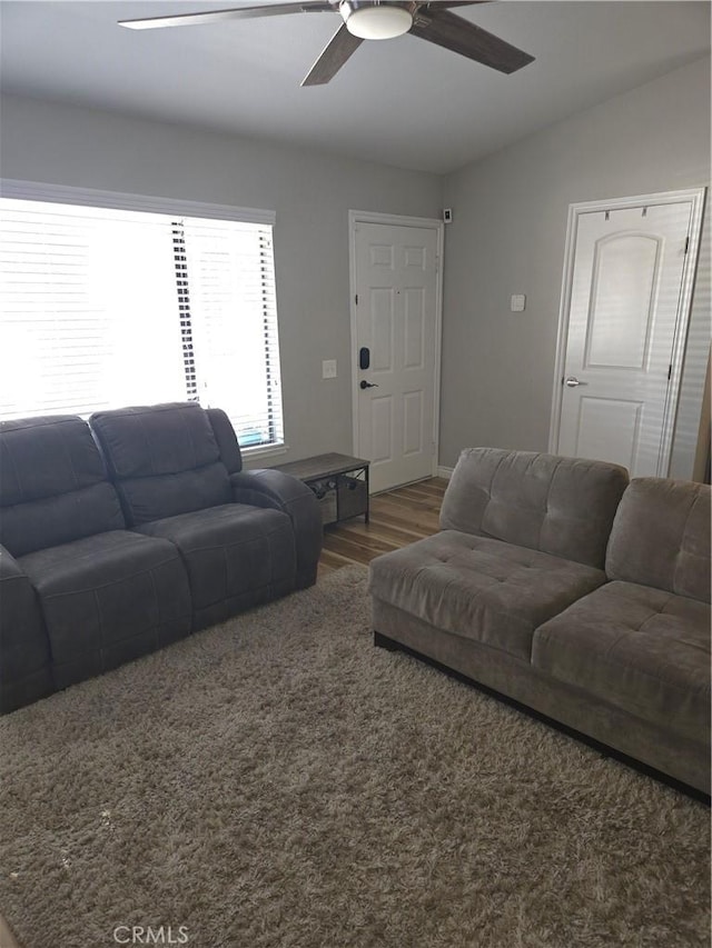 living room with hardwood / wood-style flooring, vaulted ceiling, and ceiling fan