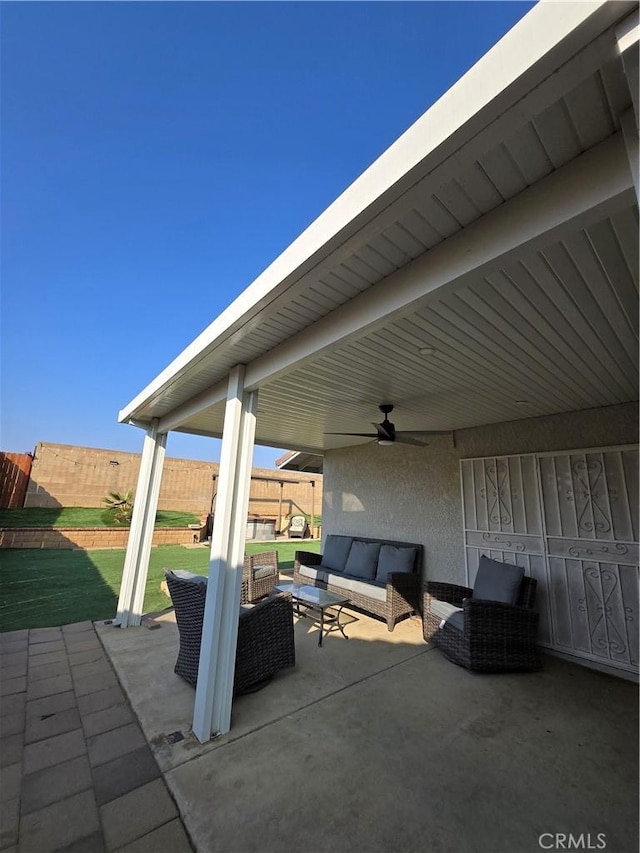 view of patio with an outdoor living space and ceiling fan