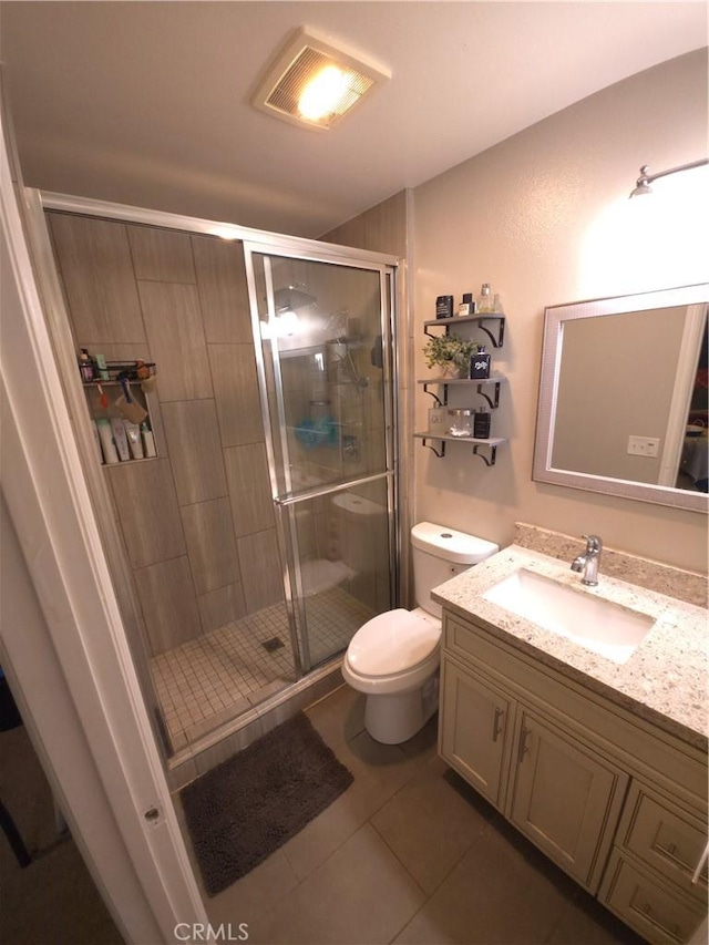 bathroom with tile patterned flooring, vanity, toilet, and an enclosed shower