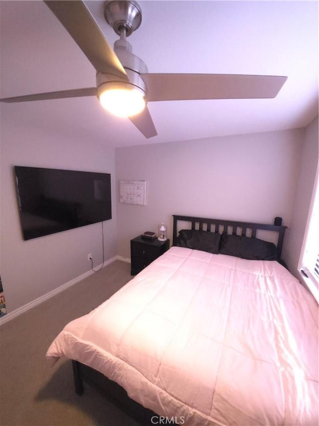 bedroom featuring ceiling fan and carpet