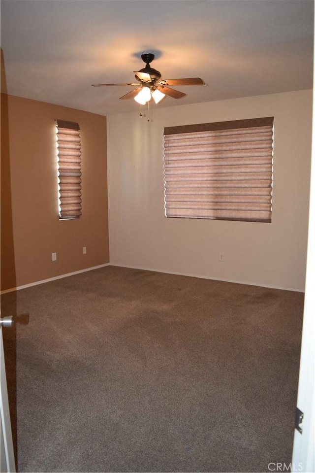 spare room with ceiling fan and carpet flooring