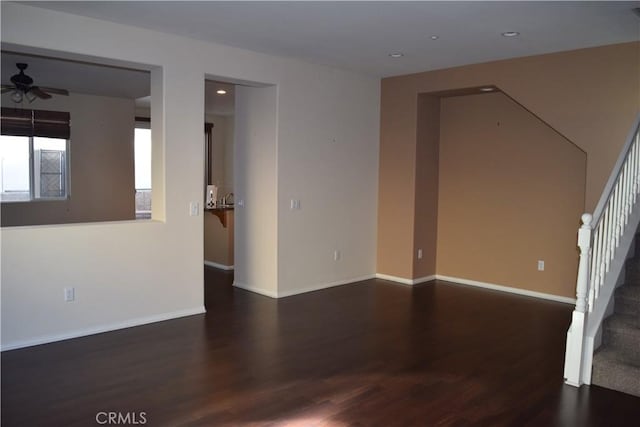 spare room featuring dark hardwood / wood-style flooring and ceiling fan