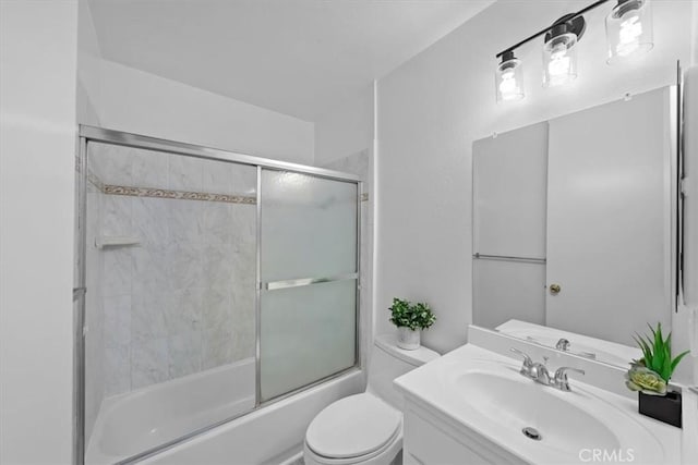 full bathroom with vanity, shower / bath combination with glass door, and toilet