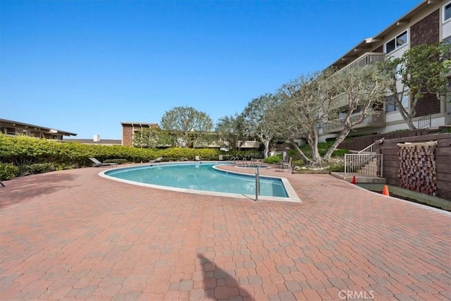 view of swimming pool featuring a patio area