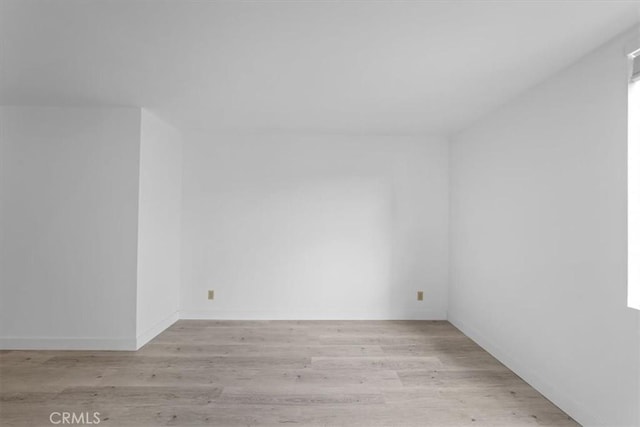 unfurnished room with light wood-type flooring