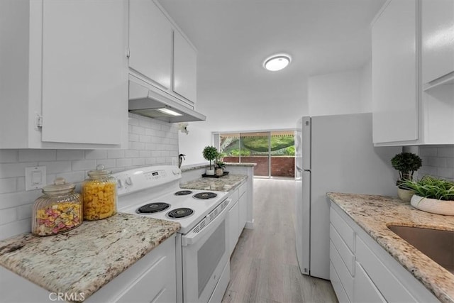 kitchen featuring light stone counters, white appliances, decorative backsplash, and white cabinets