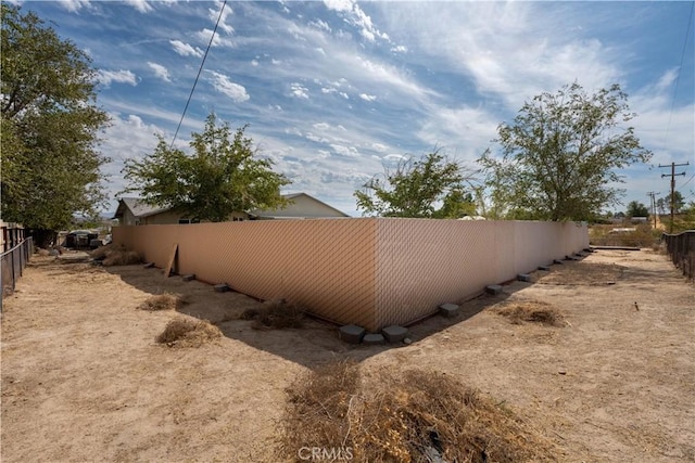 view of property exterior featuring fence