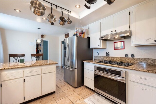 kitchen featuring white cabinetry, appliances with stainless steel finishes, pendant lighting, and light tile patterned floors