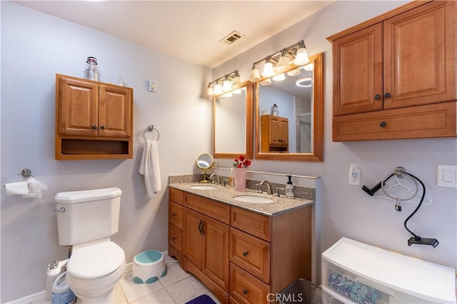 bathroom featuring vanity, tile patterned floors, and toilet