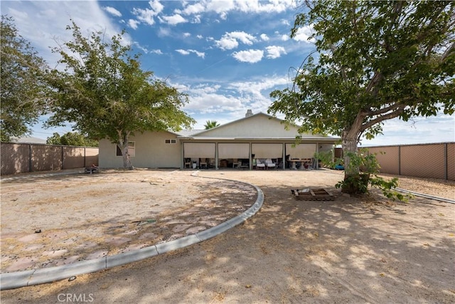 back of property featuring fence