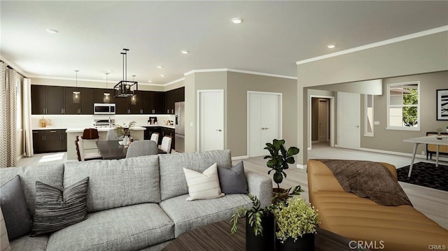 living room featuring crown molding and light hardwood / wood-style floors