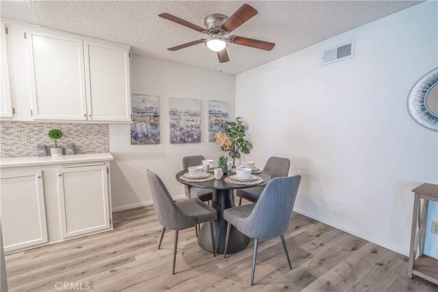 26478 Fairway Cir, Newhall, CA 91321 - dining area featuring light wood-type flooring, a ceiling fan, a textured ceiling, and baseboards