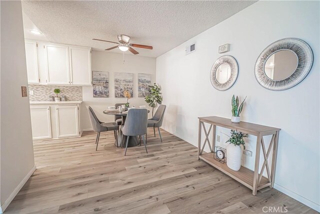 26478 Fairway Cir, Newhall, CA 91321 - dining space with ceiling fan, a textured ceiling, light wood-style floors, and baseboards