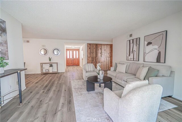 26478 Fairway Cir, Newhall, CA 91321 - living room featuring light wood-style flooring and a textured ceiling