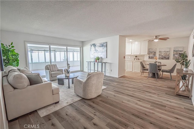 26478 Fairway Cir, Newhall, CA 91321 - living room with a textured ceiling, light wood-style floors, and a ceiling fan
