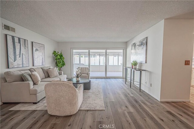 26478 Fairway Cir, Newhall, CA 91321 - living room featuring wood finished floors, a textured ceiling, and baseboards