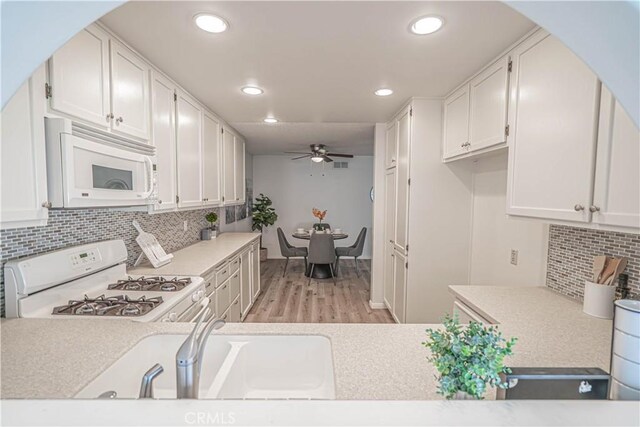 26478 Fairway Cir, Newhall, CA 91321 - kitchen with white appliances, a ceiling fan, white cabinets, light wood-type flooring, and recessed lighting