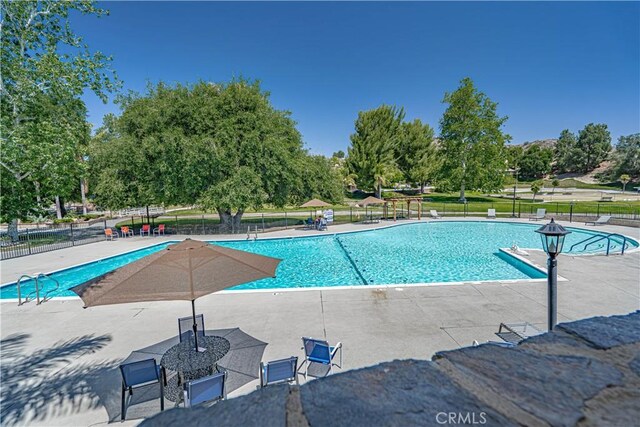 26478 Fairway Cir, Newhall, CA 91321 - community pool with a patio area and view of scattered trees