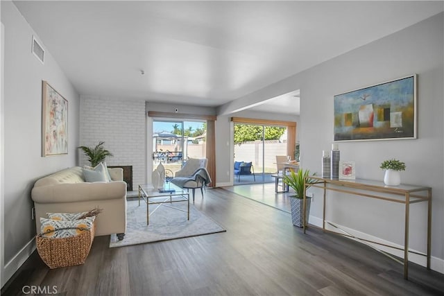 living area featuring a fireplace and wood-type flooring