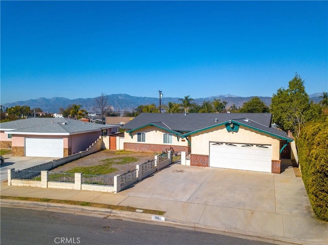 single story home with a mountain view and a garage