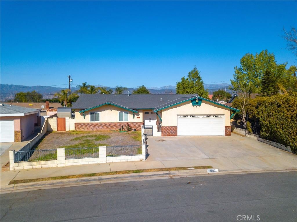 ranch-style home with a garage and a mountain view