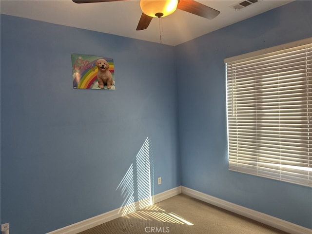 spare room with carpet floors and ceiling fan