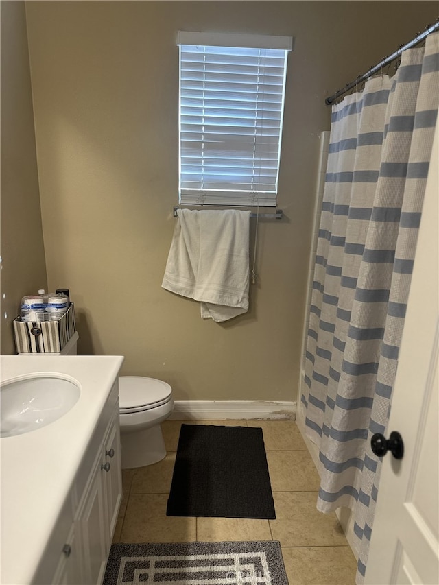 bathroom featuring vanity, tile patterned floors, and toilet