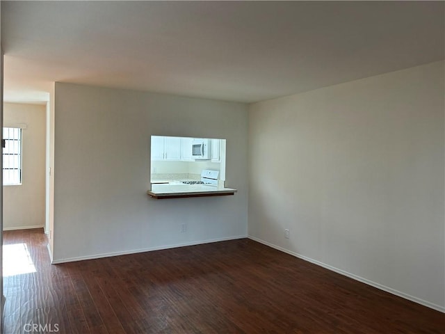 empty room featuring dark hardwood / wood-style flooring