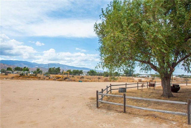 view of yard with a mountain view and a rural view