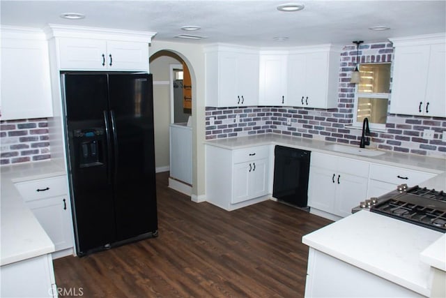 kitchen with sink, white cabinets, dark hardwood / wood-style flooring, and black appliances