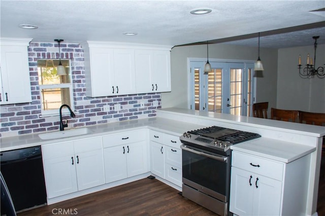 kitchen featuring pendant lighting, dishwasher, stainless steel gas stove, white cabinetry, and kitchen peninsula