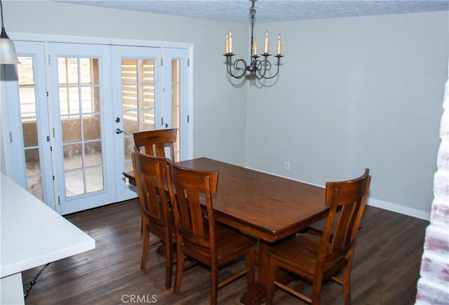 dining room with an inviting chandelier, dark hardwood / wood-style flooring, french doors, and a textured ceiling