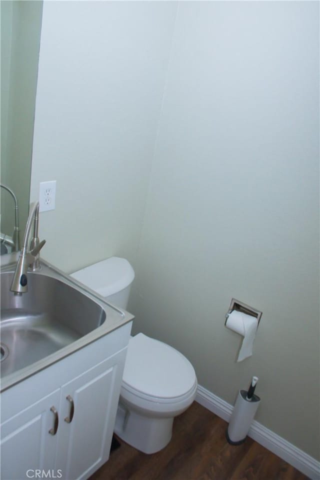 bathroom featuring vanity, hardwood / wood-style floors, and toilet